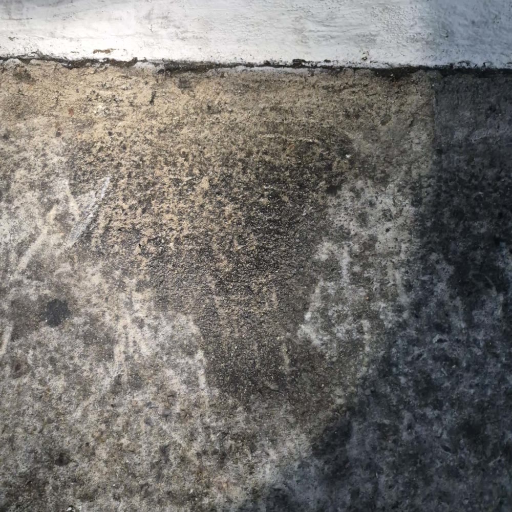 Moisture staining on a concrete slab floor.