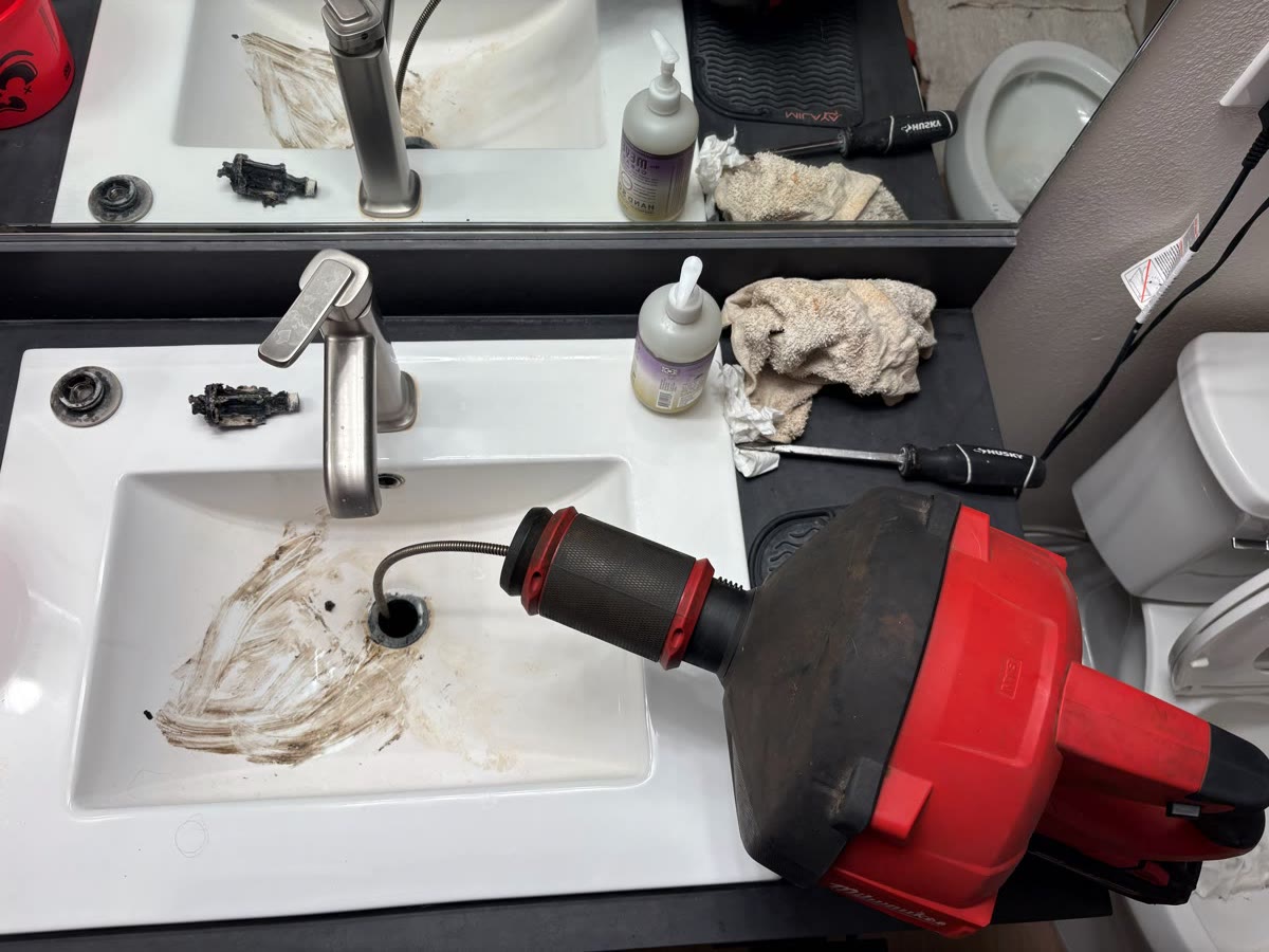 A drain cable clearing a clogged sink line
