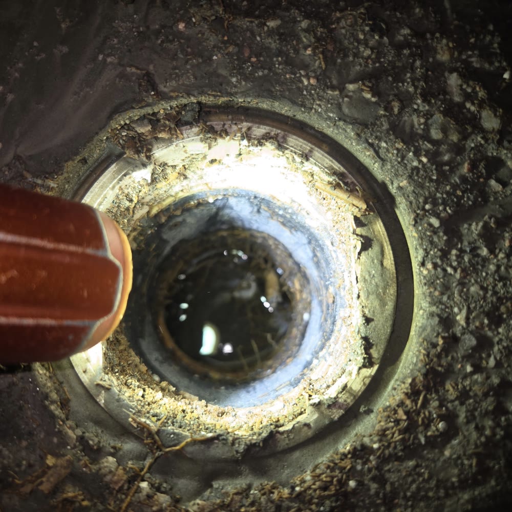 Jetter nozzle going into a ground cleanout.