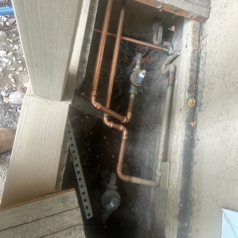 New copper water piping in an access pit.