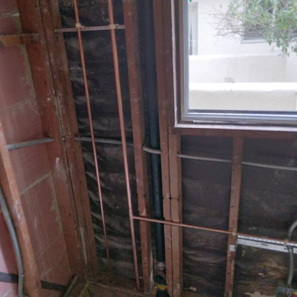 New copper supply lines in an opened wall.