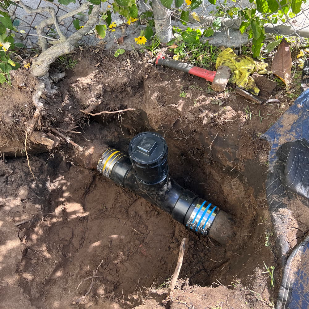 New two way sewer cleanout in a hand dug pit.