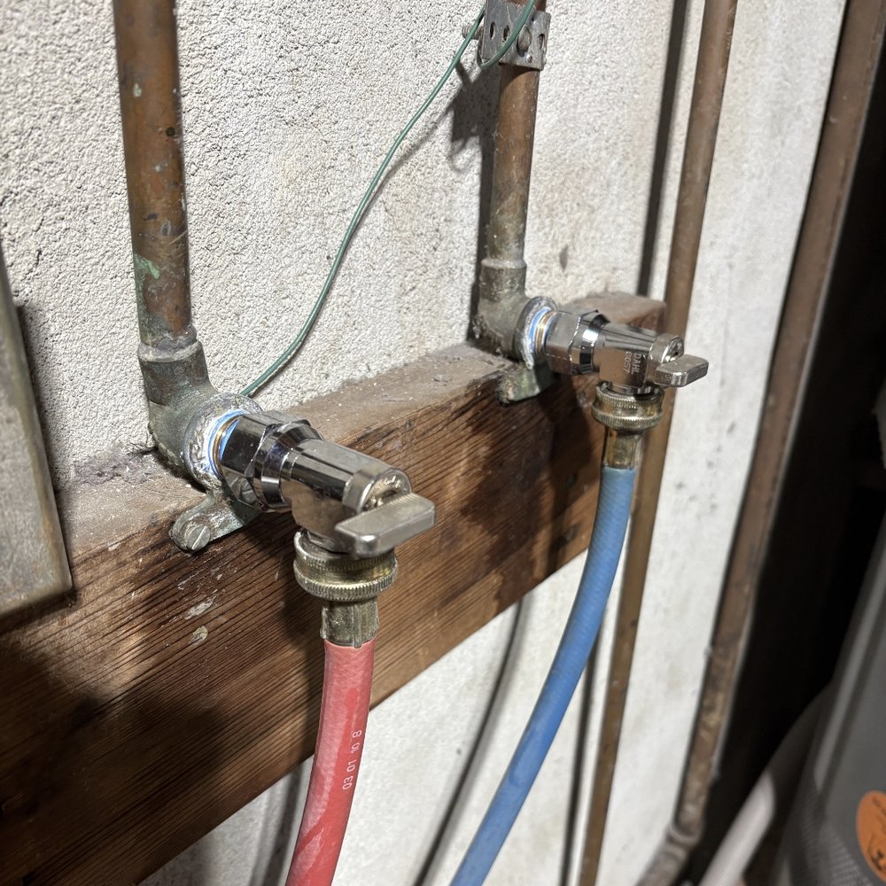 New washing machine shutoff valves with hot and cold hoses.