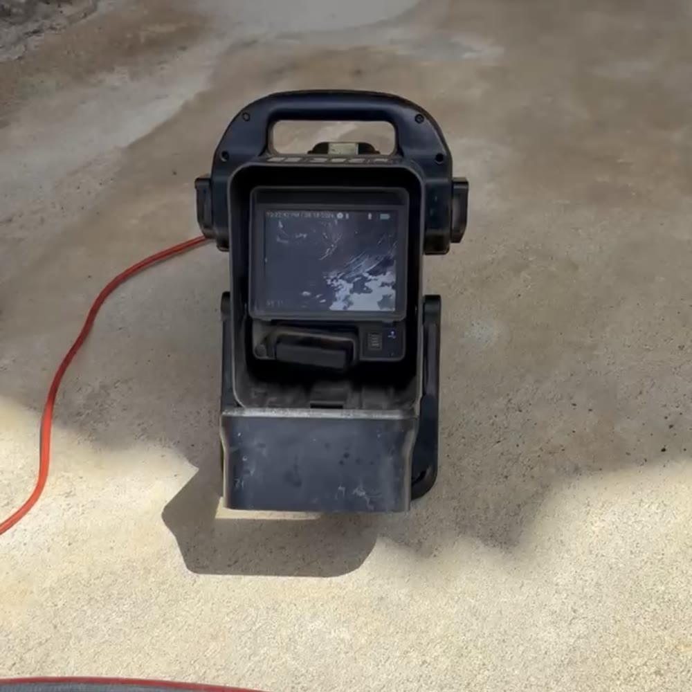 Sewer camera monitor unit on a concrete pad.