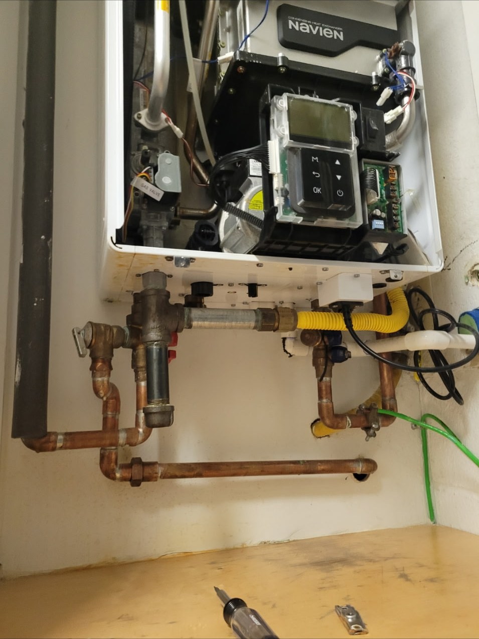 Tankless water heater with the service panel open.