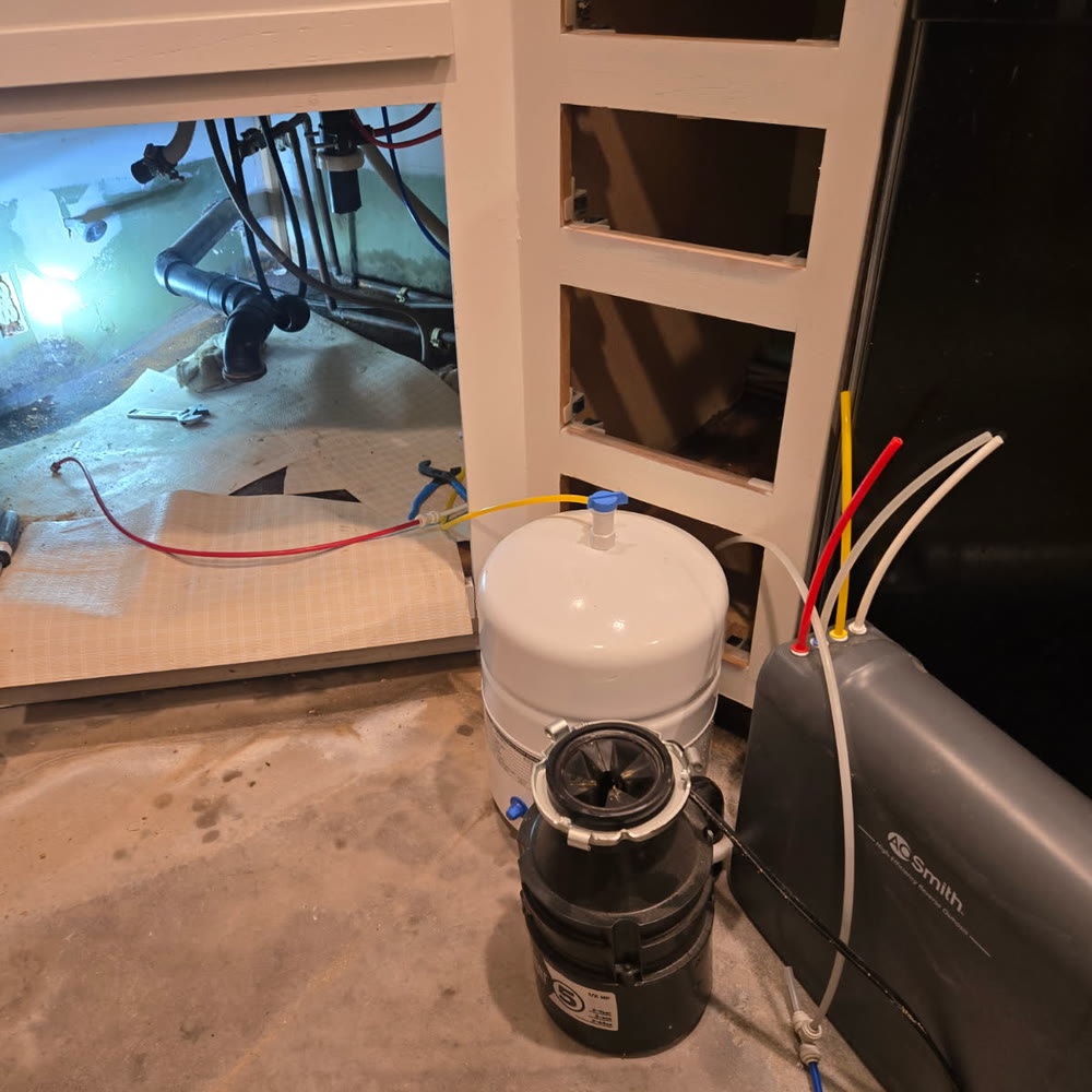 Under sink filtration system being installed.