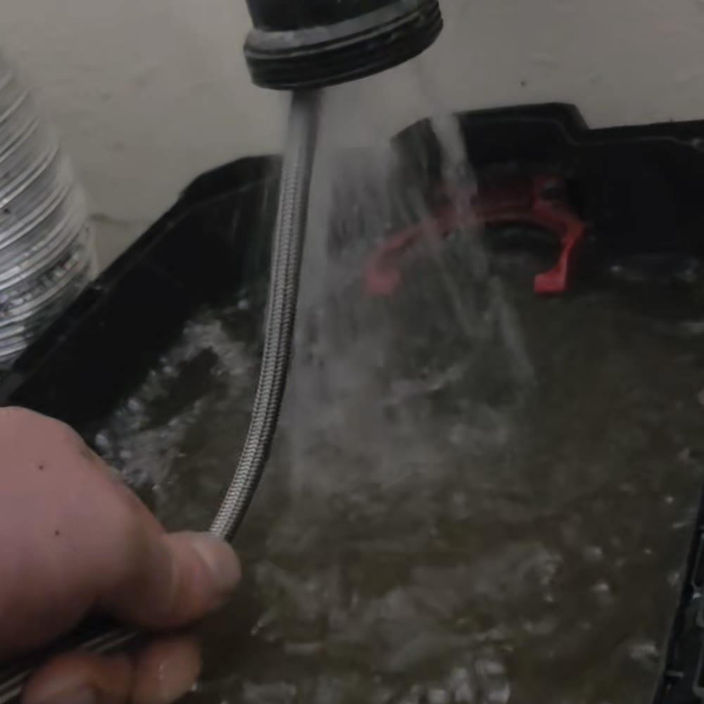 Water blasting out of a drain line during jetting.